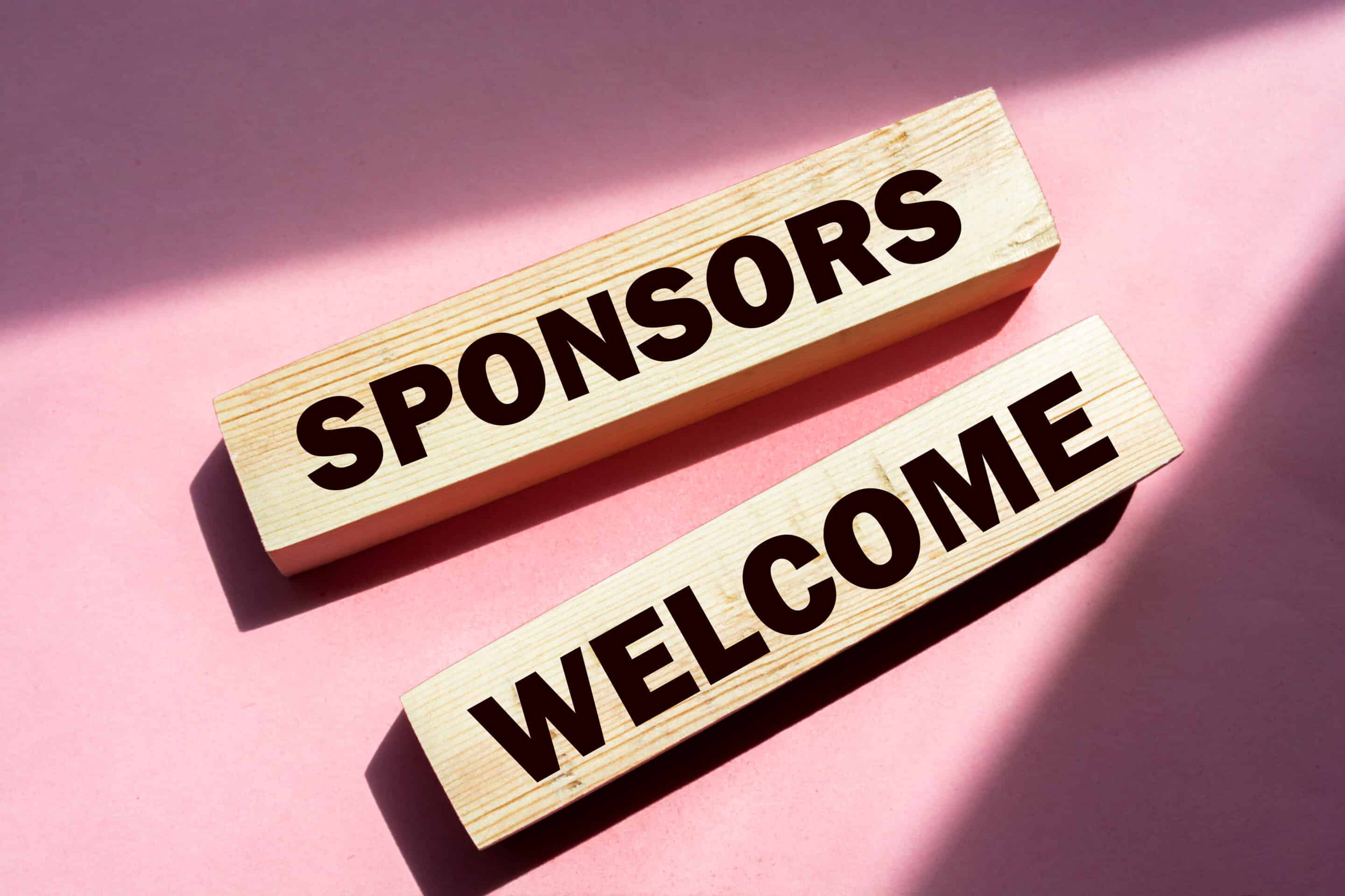 SPONSORS WELCOME on wooden blocks. Sponsorship donation support business startup concept. Commercial Sponsorship
